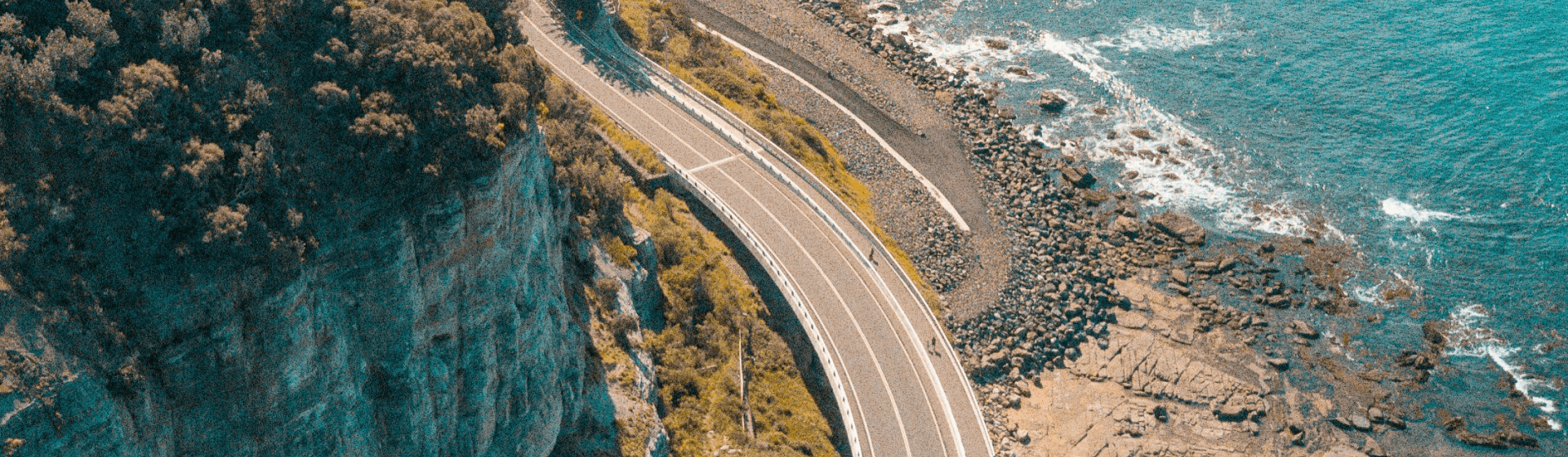 road in the middle of a mountain and the sea desk