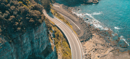 road in the middle of a mountain and the sea